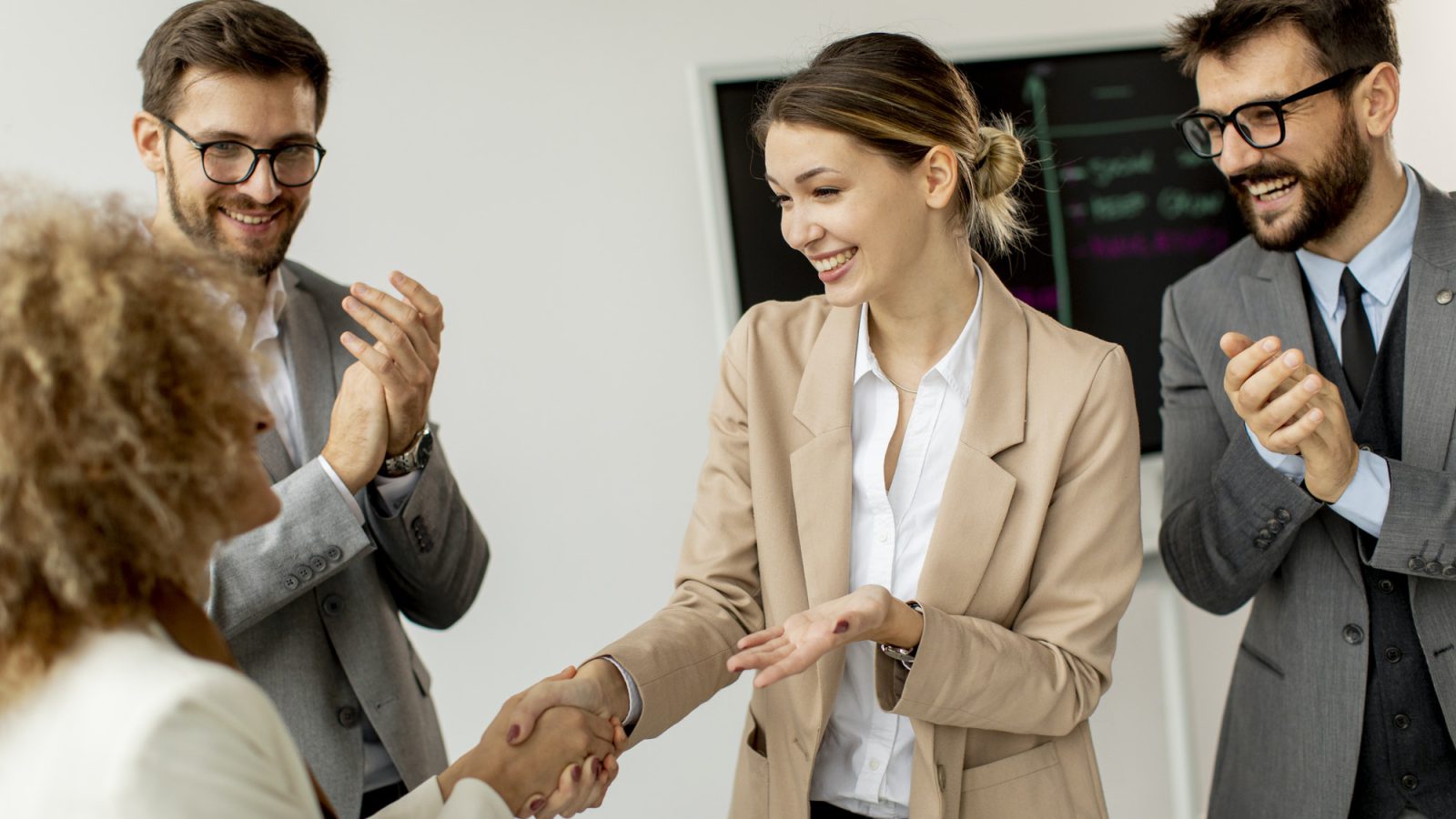 Group of young business people making a deal at a meeting in the office